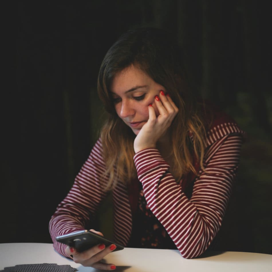 Chica joven mirando la pantalla de su móvil